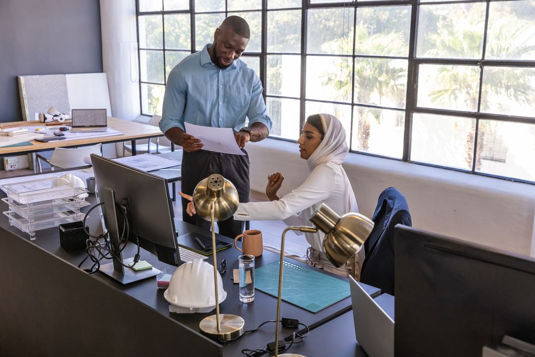 Diverse Coworkers Collaborating in Modern Workplace with Technology