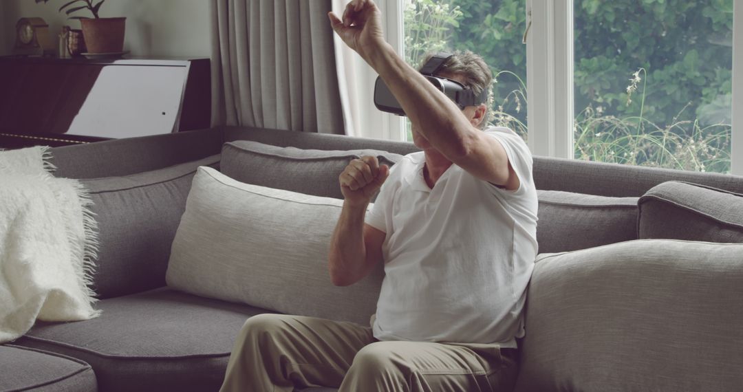 Senior Man Enjoying Virtual Reality Experience in Living Room - Free Images, Stock Photos and Pictures on Pikwizard.com