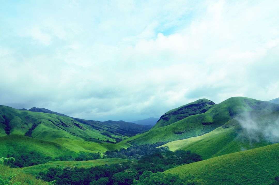 Lush Green Hills and Misty Mountains - Free Images, Stock Photos and Pictures on Pikwizard.com