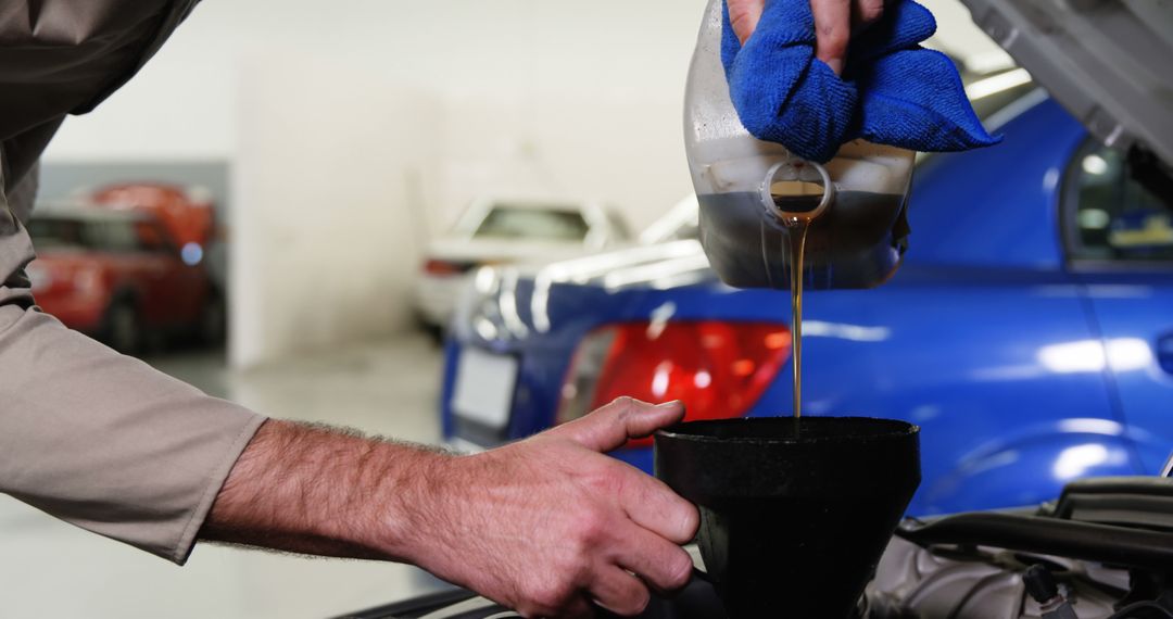 Mechanic Pouring Engine Oil in Car Engine at Auto Repair Shop - Free Images, Stock Photos and Pictures on Pikwizard.com