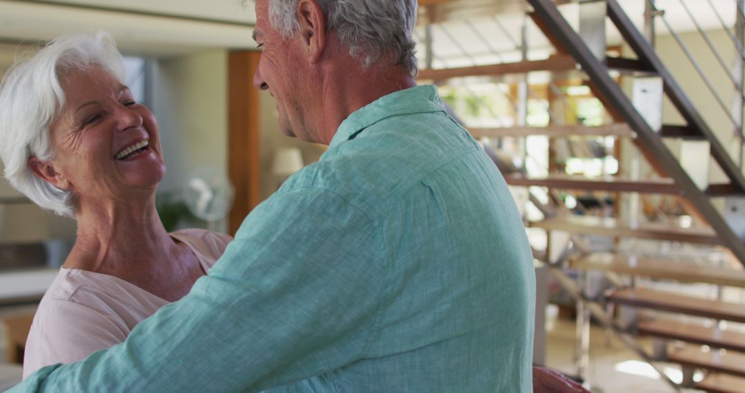 Happy Senior Couple Embracing at Home with Warm Smiles