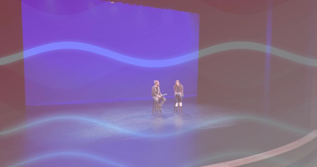 Theater Presentation with Two Speakers Discussing Under Spotlights