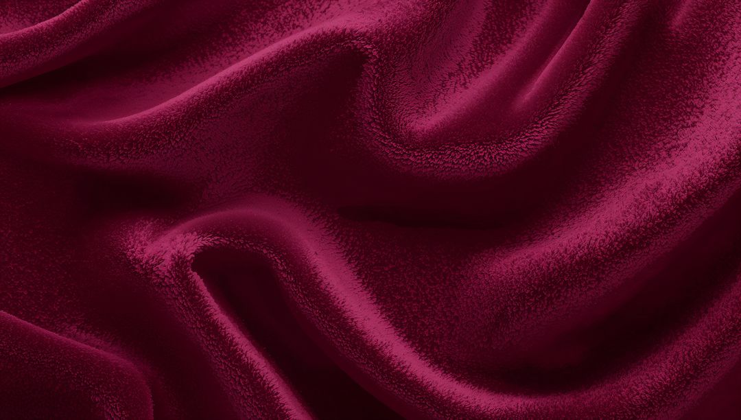 Draping deep wine-red velvet fabric revealing plush folds and soft sheen