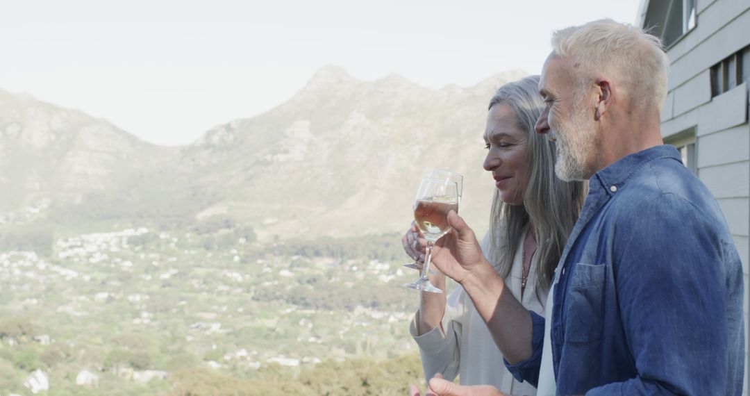 Middle Aged Couple Enjoying Wine on Mountainous Terrace - Free Images, Stock Photos and Pictures on Pikwizard.com