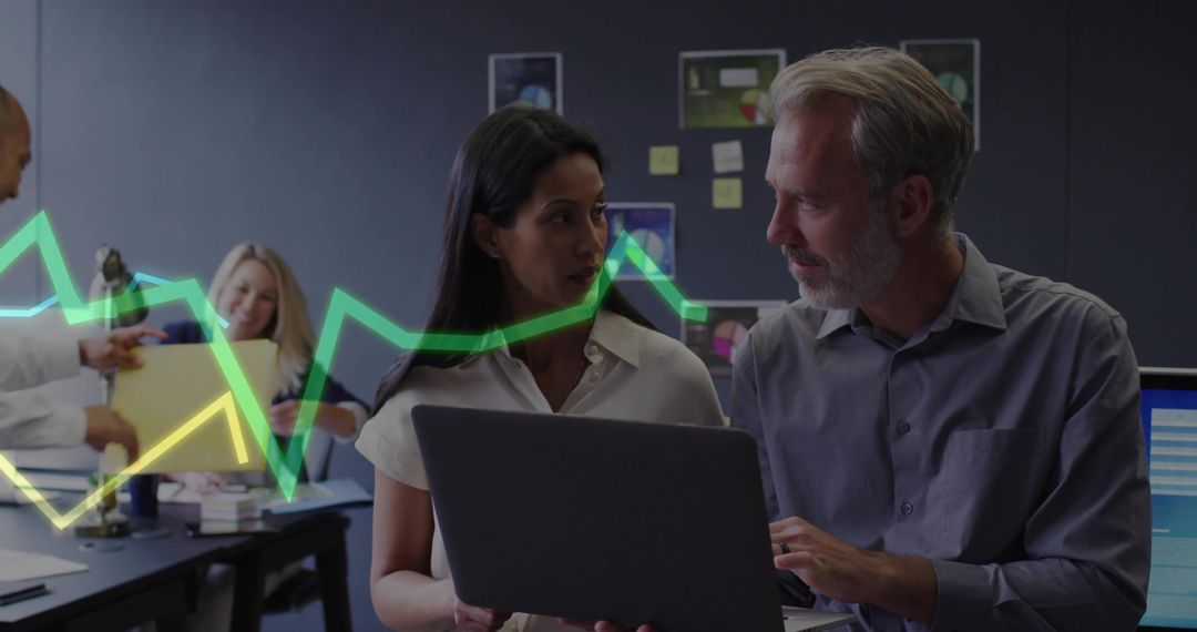 Business Colleagues Discussing Data on Laptop at Office Workspace