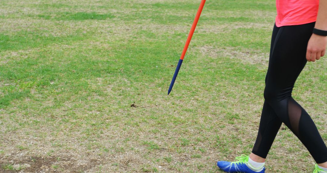Female Athlete Practicing Javelin Throw Holding Javelin