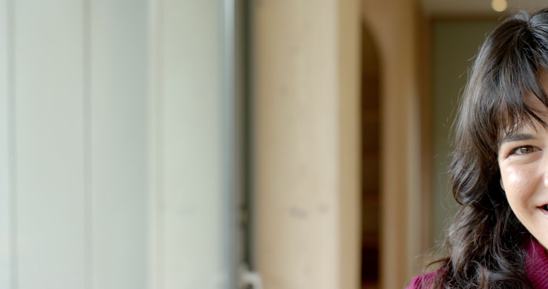 Woman Smiling Near Frosted Window with Modern Architecture