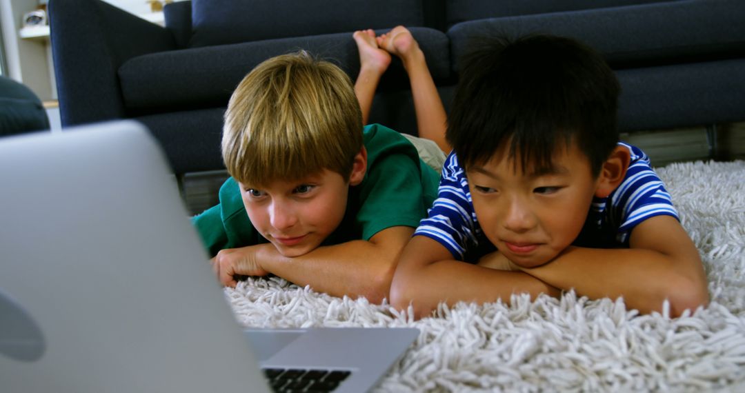 Kids Lying on Carpet Watching Laptop Screen Together - Free Images, Stock Photos and Pictures on Pikwizard.com