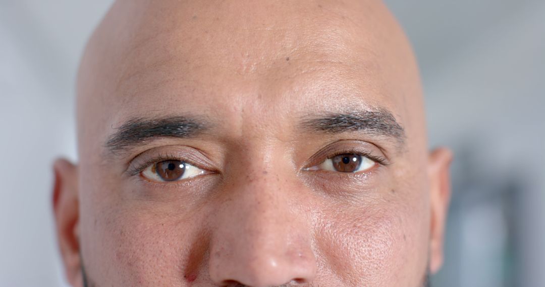 Close-Up of a Bald Man's Face with Intense Gaze - Free Images, Stock Photos and Pictures on Pikwizard.com