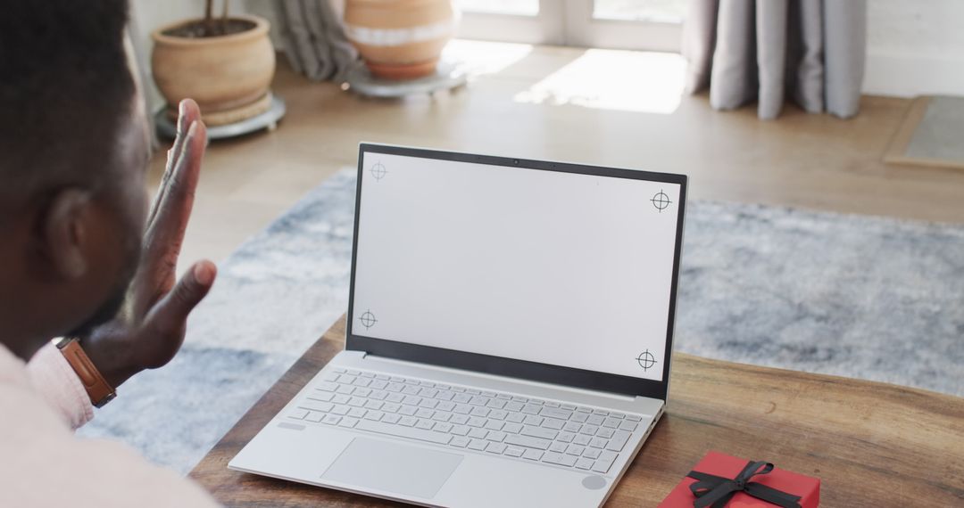 Man Engaged in Online Video Call with Laptop in Cozy Home Setting