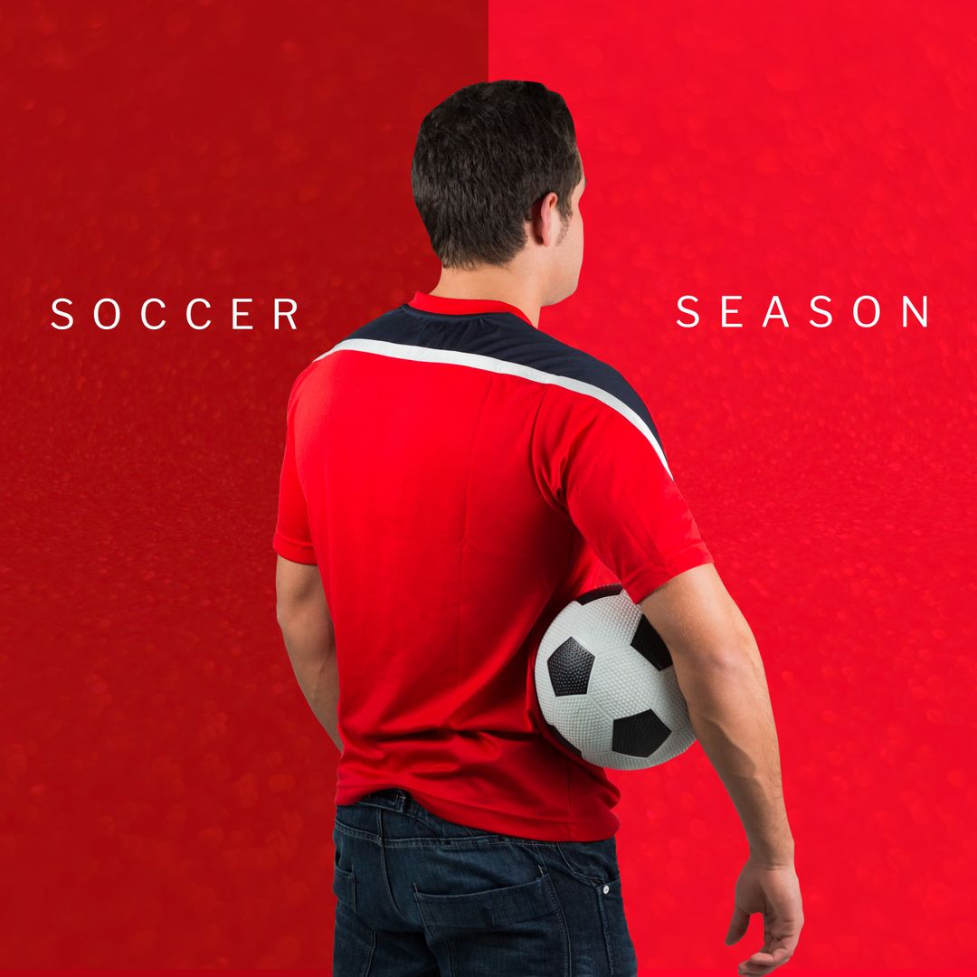 Back View of Male Soccer Player in Red Uniform Holding Ball