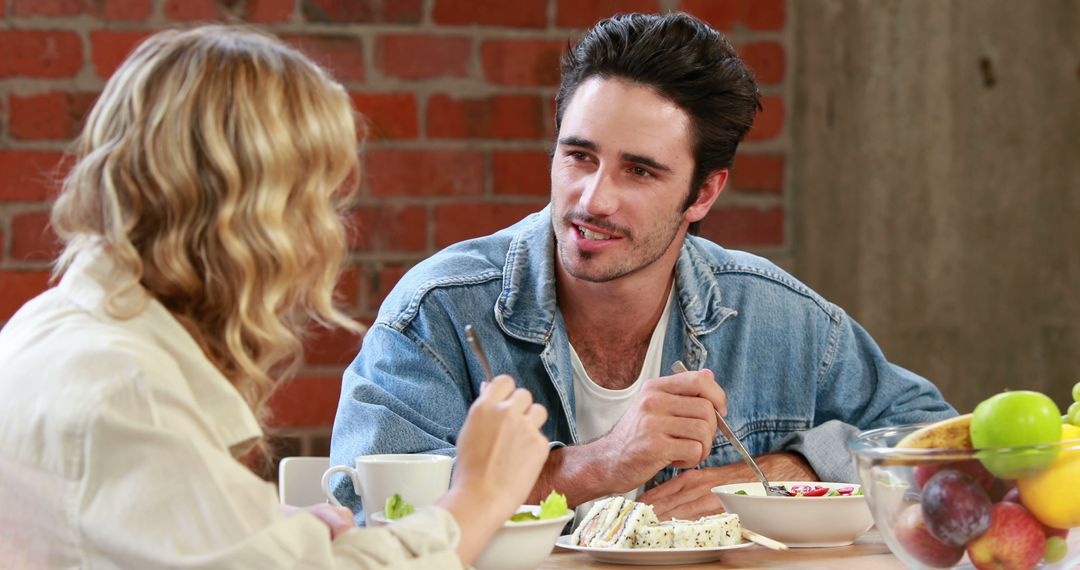 Young Caucasian Couple Talking and Eating Breakfast Together - Free Images, Stock Photos and Pictures on Pikwizard.com