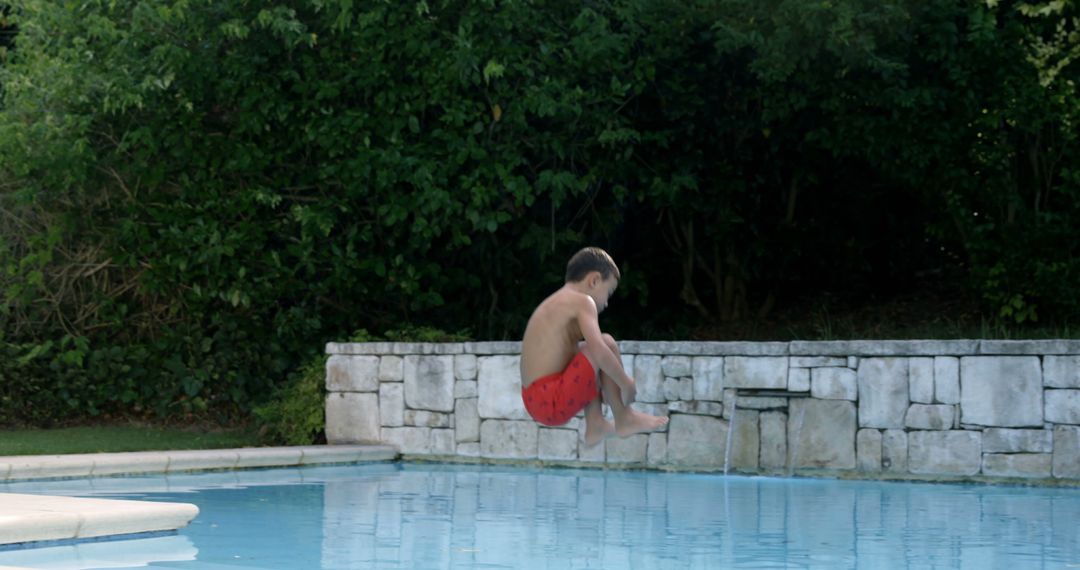 Young Boy Jumping into Pool with Cannonball Splash - Free Images, Stock Photos and Pictures on Pikwizard.com