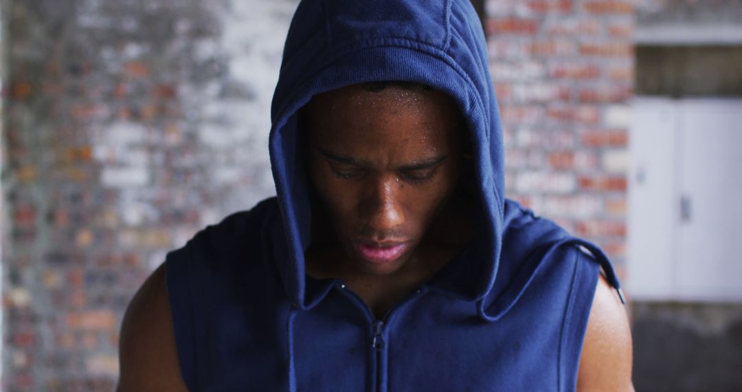 Sweaty African American man in a hoodie embodies urban fitness after exercising. - Free Images, Stock Photos and Pictures on Pikwizard.com