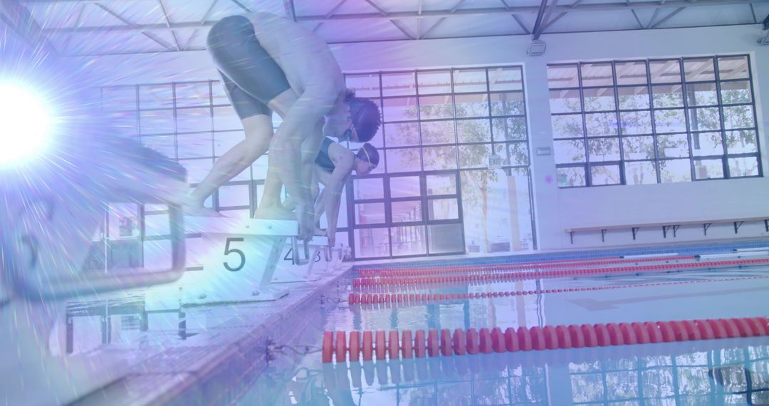 Competitive Swimmers Preparing to Dive in Indoors Pool