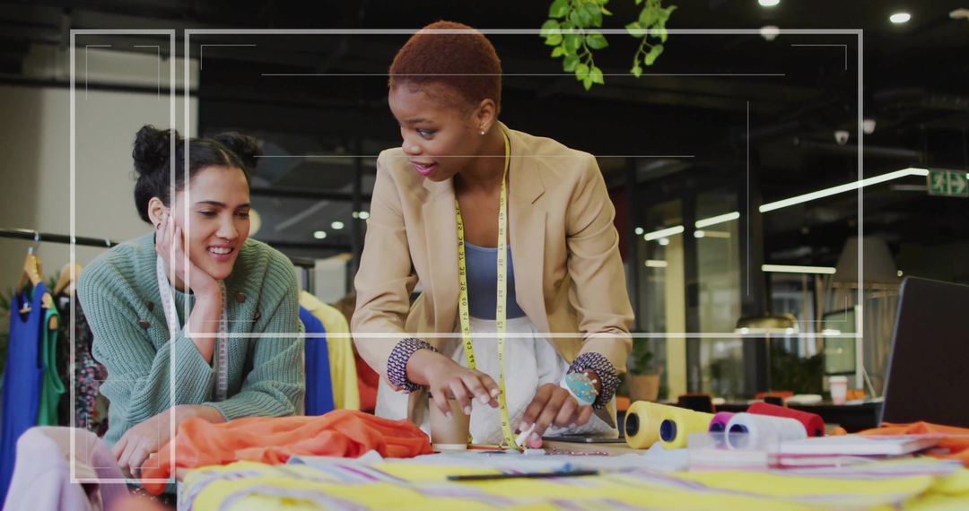 Designers Collaborating on Fabric Patterns in Fashion Studio