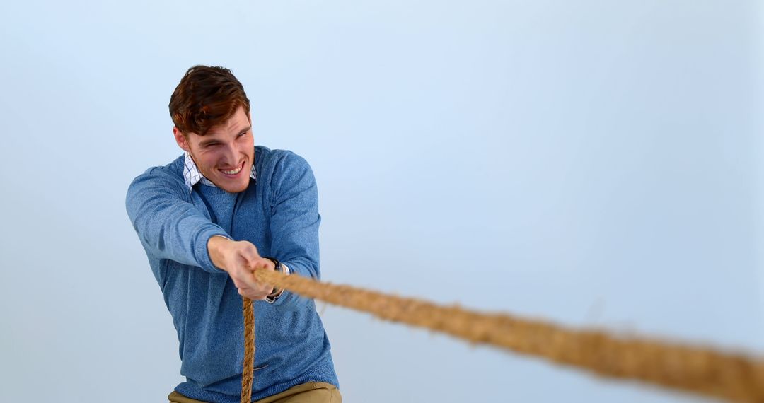 Man Pulling Rope, Engaging in Tug of War, Determination and Strength - Free Images, Stock Photos and Pictures on Pikwizard.com