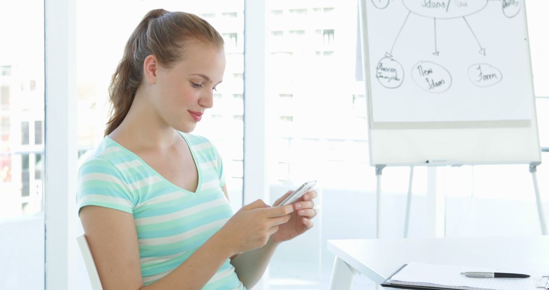 Casual Businesswoman Texting in Modern Office Environment - Free Images, Stock Photos and Pictures on Pikwizard.com