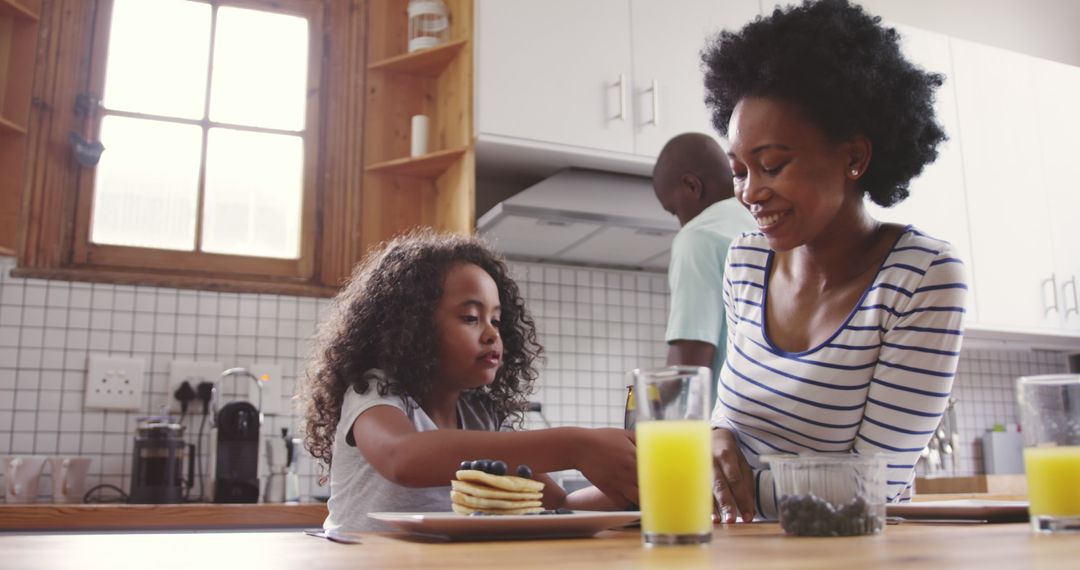 Happy African American Family Enjoying Breakfast Together in Modern Kitchen - Free Images, Stock Photos and Pictures on Pikwizard.com