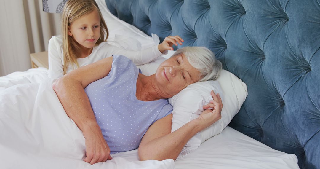 Young Girl Relaxing with Elderly Grandmother in Bed - Free Images, Stock Photos and Pictures on Pikwizard.com