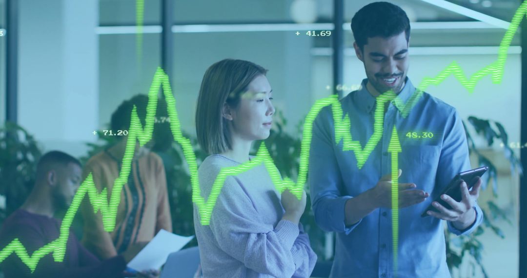 Diverse Team Analyzing Financial Data on Tablet in Office