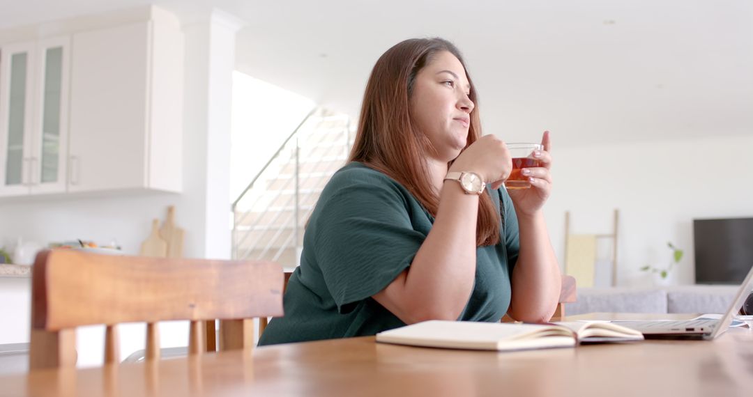 Pensive Plus Size Woman Working Remotely with Tea at Home