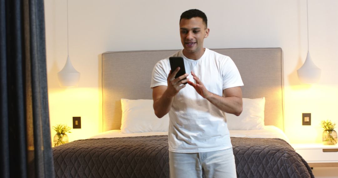 Man Video Chatting on Smartphone in Modern Bedroom Interior