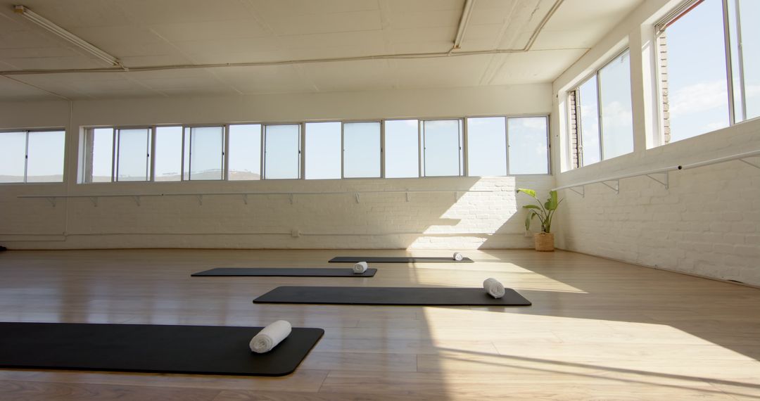 Relaxing Yoga Studio Interior with Sunlight Streaming through Windows