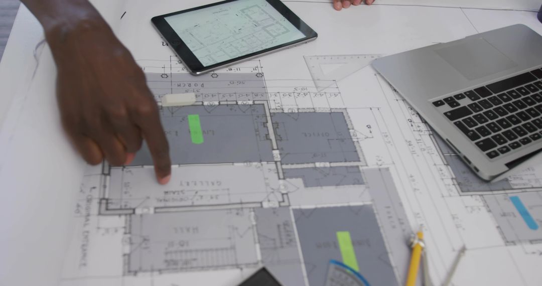 Architects Collaborating on Project with Blueprint and Gadgets