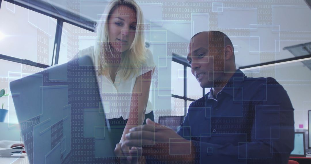 Colleagues Analyzing Technology Data Overlay on Laptop Screen