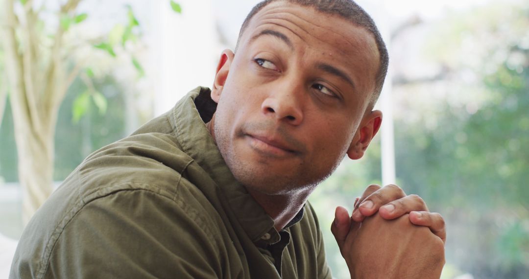 Thoughtful Man Contemplating Indoors, Casual Home Setting