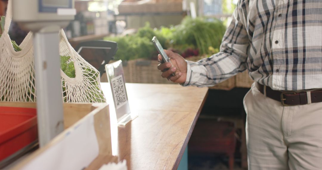 Customer Using Smartphone to Scan QR Code for Payment at Market - Free Images, Stock Photos and Pictures on Pikwizard.com