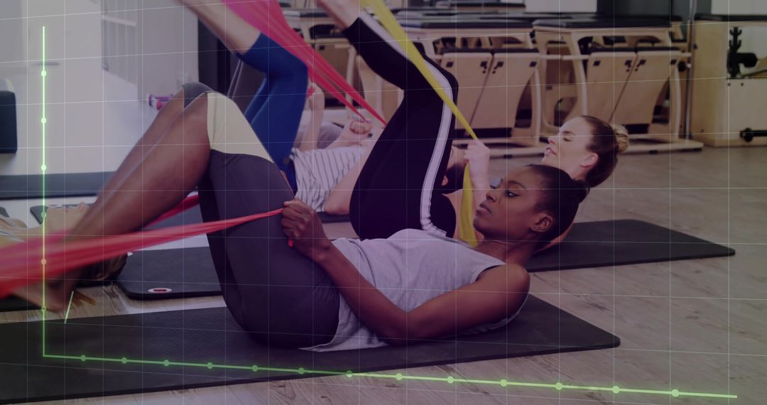 Women Practicing Pilates with Resistance Bands for Flexibility and Recovery