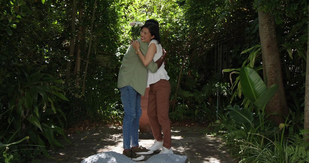 Couple Sharing Flowers in a Lush Garden Embracing Joyfully
