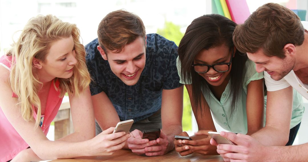 Diverse Young Adults Socializing with Smartphones in Modern Living Room