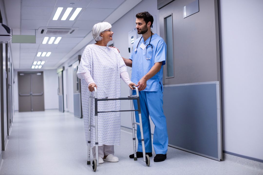 Doctor Assisting Senior Patient with Walker in Hospital Corridor - Free Images, Stock Photos and Pictures on Pikwizard.com