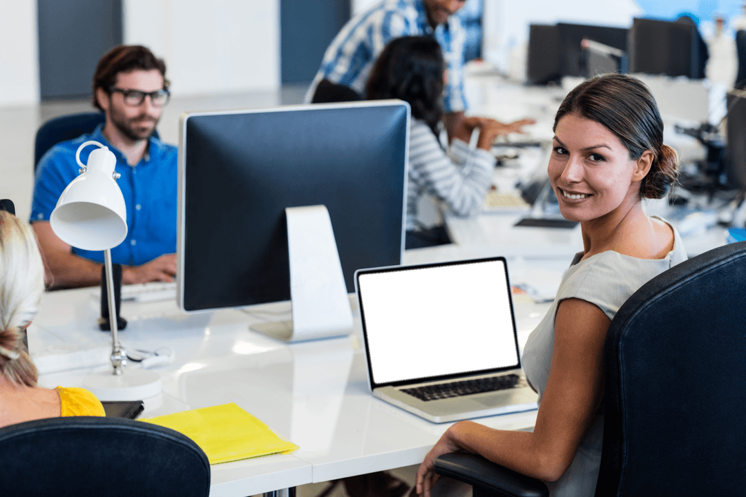 Businesswoman Smiling at Transparent Desk with Busy Team at Open Office