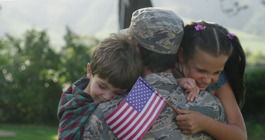 Soldier Hugging Children Holding American Flag - Free Images, Stock Photos and Pictures on Pikwizard.com