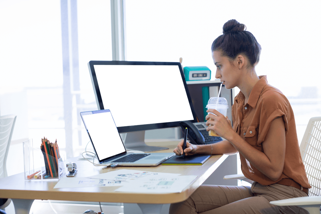 Female Designer Using Graphic Tablet in Modern Office on Transparent Screens
