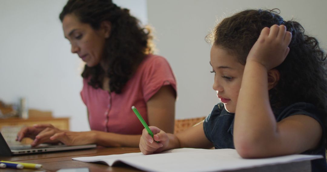 Mother and Daughter Doing Homework Together at Home