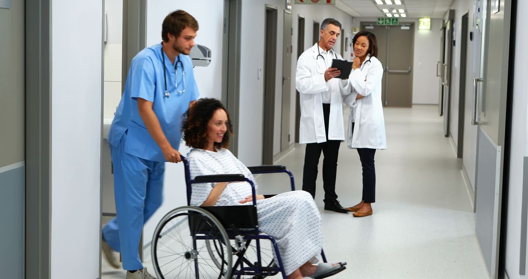 Healthcare Professionals Assisting Patient in Hospital Corridor - Free Images, Stock Photos and Pictures on Pikwizard.com