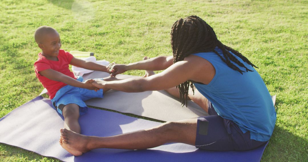 Father and Son Stretching Together on Yoga Mats Outdoors - Free Images, Stock Photos and Pictures on Pikwizard.com