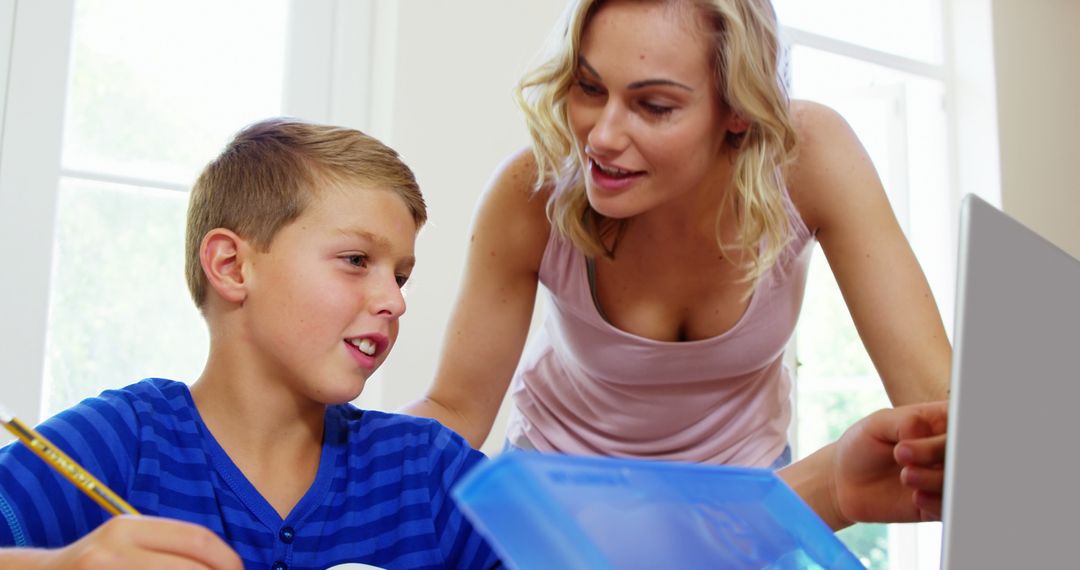 Mother Helping Son with Homework on Laptop - Free Images, Stock Photos and Pictures on Pikwizard.com