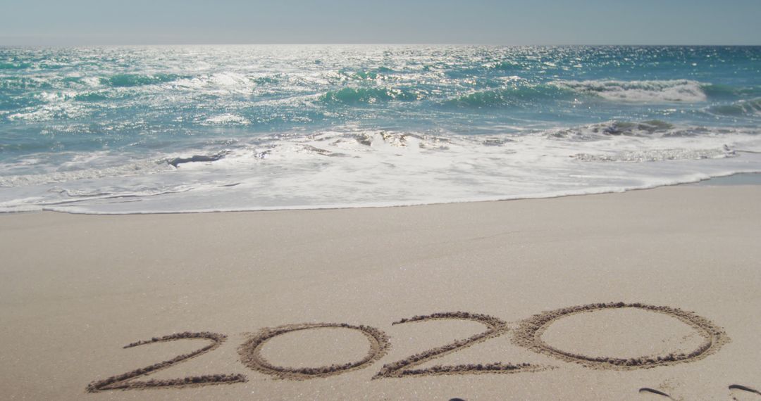 2020 Written in Sand on Ocean Beach with Waves - Free Images, Stock Photos and Pictures on Pikwizard.com