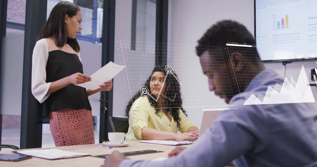 Colleagues Analyzing Digital Data in Modern Office Meeting