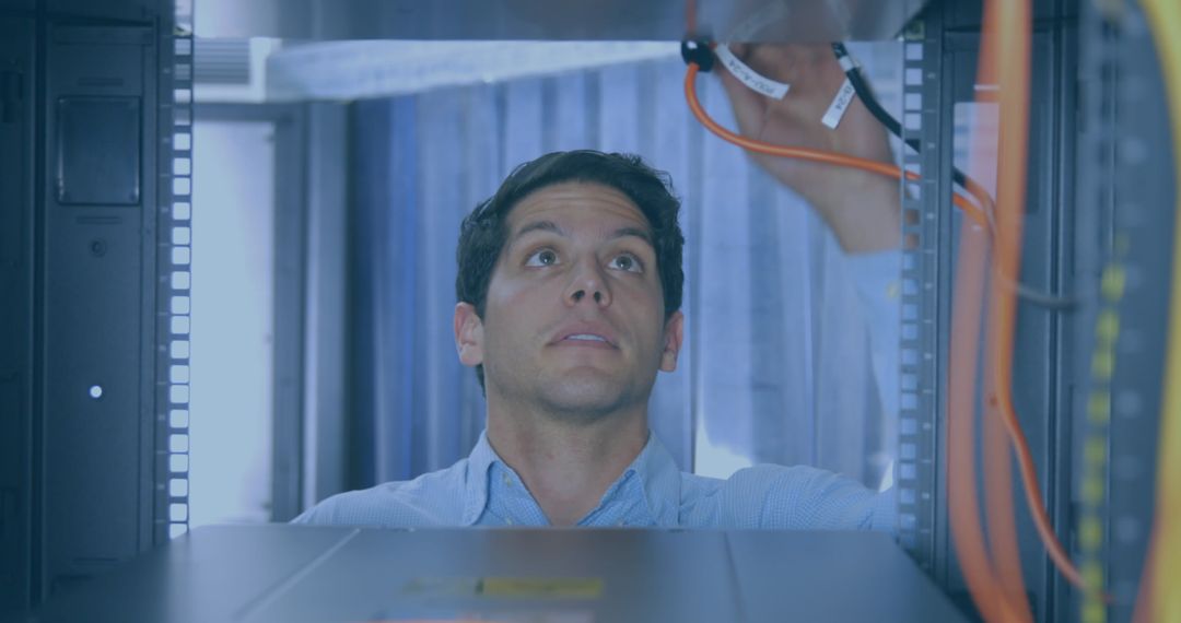 Technician Connecting Network Cables in Data Center Server Room