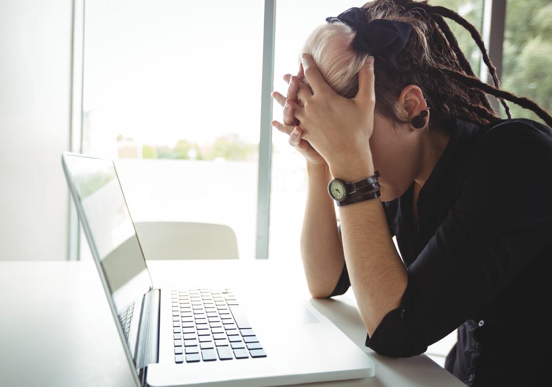 Image of a stressed woman using a laptop - Reasons why you should embrace negative feedback - Image