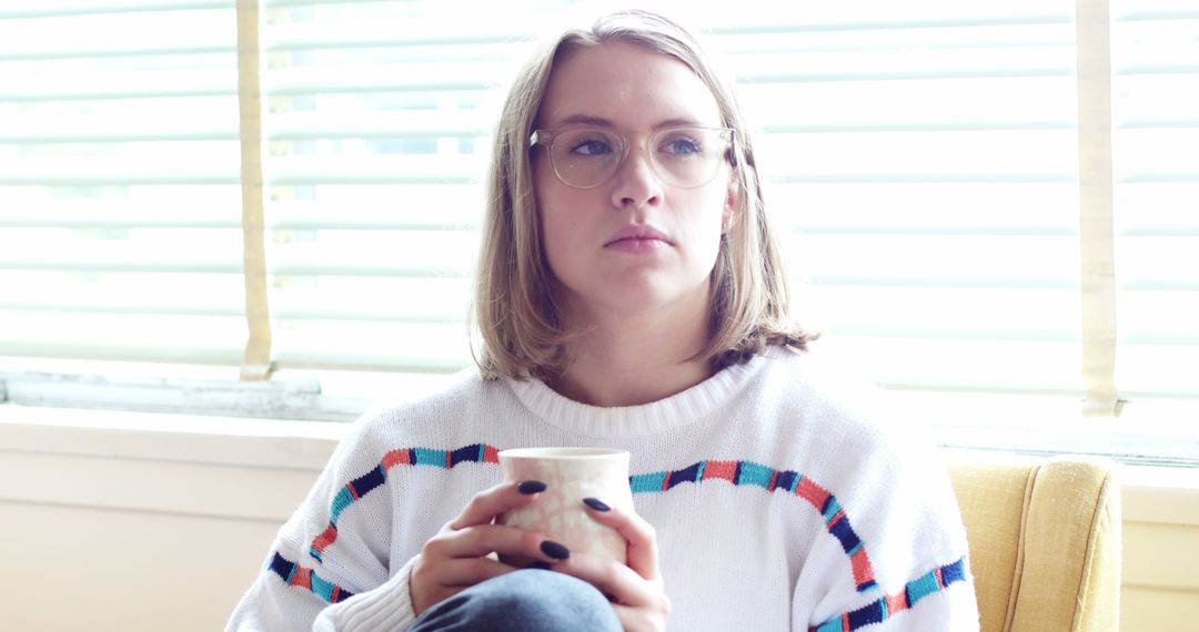 Pensive Woman Holding Coffee Cup Near Window - Free Images, Stock Photos and Pictures on Pikwizard.com