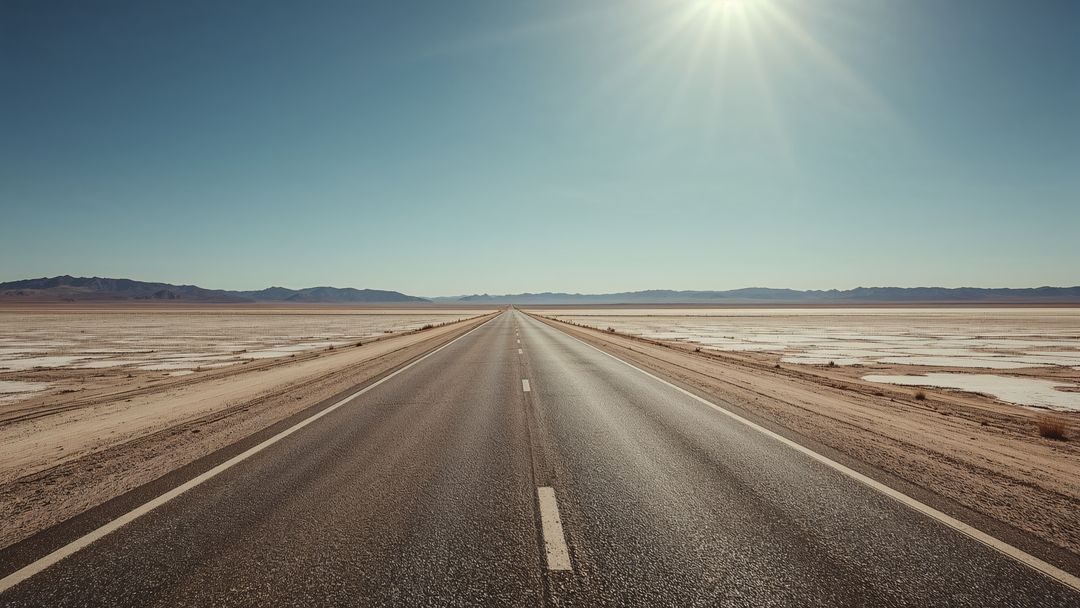 Endless Open Road through Vast Salt Desert Beneath Bright Sun