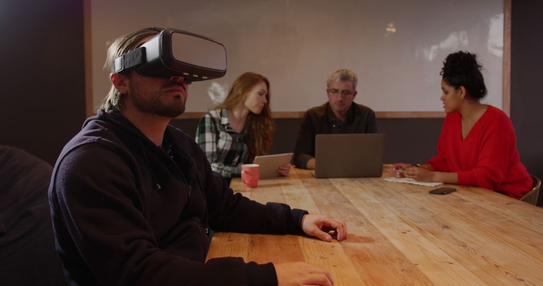 Group Collaborating with VR Headset in Modern Office - Free Images, Stock Photos and Pictures on Pikwizard.com